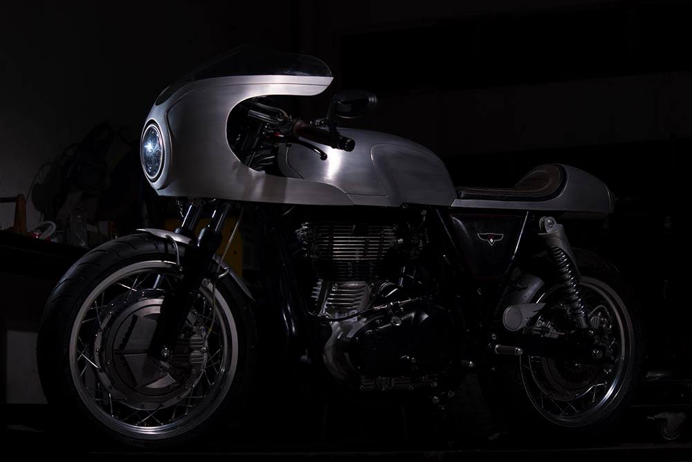 Royal Enfield Continental GT Silver Bullet by white collar bike left side