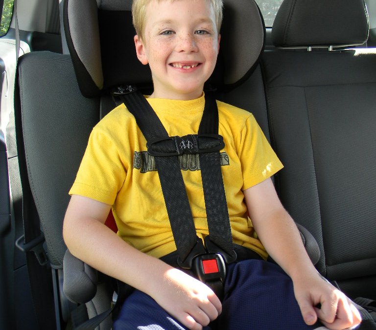 Child safety seat outlet restraint system