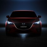 Mazda3 headlamps illuminated in the dark