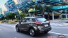 Nissan Kicks official image rear three quarters left side urban driving shot