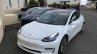 Tesla Model 3 white front three quarters left side spy shots