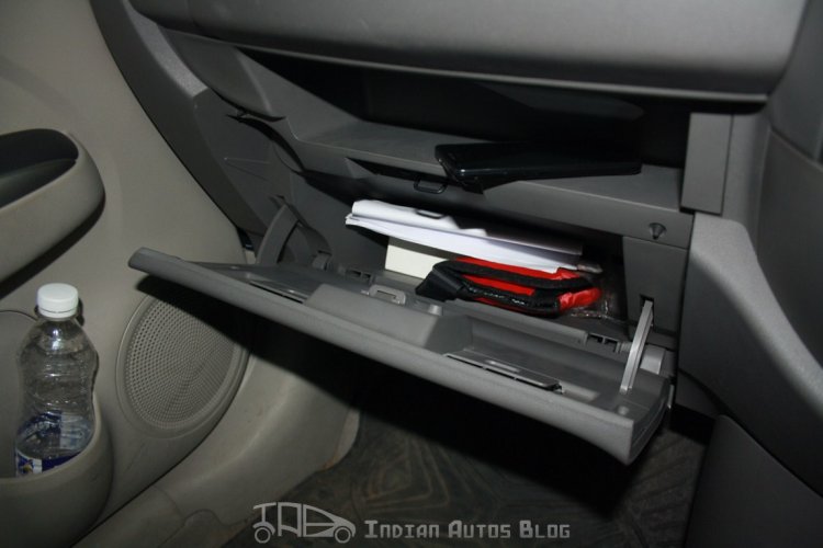 A tray above the glovebox can be used to store files or stuff the trash