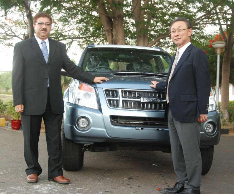 Mr Uttam Bose MD CEO HM Ltd (left) and Mr Takashi Kikuchi, President, Isuzu Motors India standing in front of Isuzu sport utility vehicle MU-7 at HM Thiruvallur plant near Chennai on June 28 2013