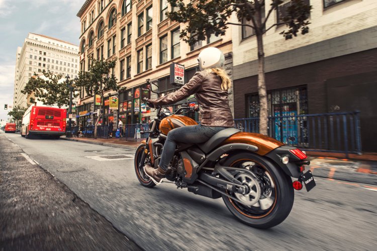 Kawasaki Vulcan S Pearl Lava Orange press rear angle action